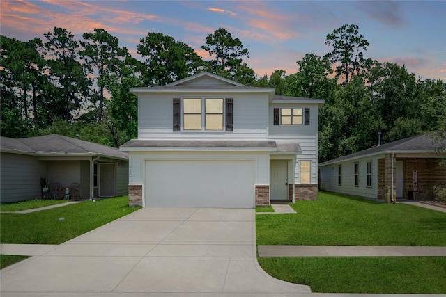 9826 Orchid Spring Ln, Houston, TX 77044 - view of front of home featuring an attached garage, driveway, a front lawn, and stone siding
