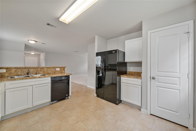 9826 Orchid Spring Ln, Houston, TX 77044 - kitchen with black appliances, white cabinets, and light stone countertops