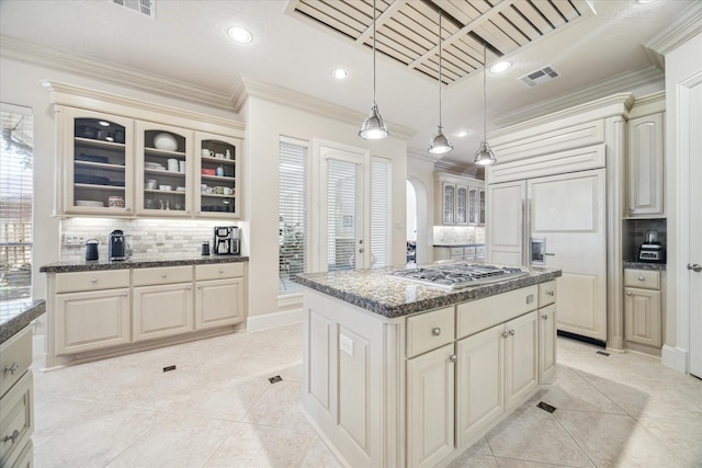 718 Marywood Chase, Houston, TX 77079 - kitchen featuring arched walkways, stainless steel gas cooktop, tasteful backsplash, ornamental molding, and paneled fridge
