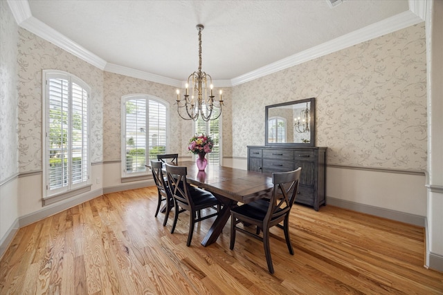 718 Marywood Chase, Houston, TX 77079 - dining space with a chandelier, wood finished floors, wallpapered walls, and ornamental molding