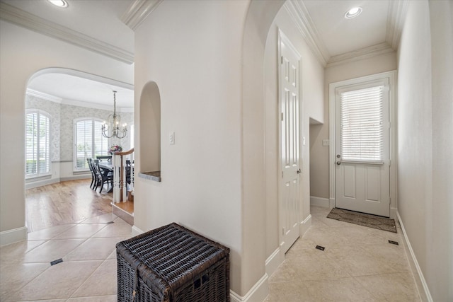 718 Marywood Chase, Houston, TX 77079 - foyer entrance featuring arched walkways, tile patterned floors, a chandelier, and crown molding