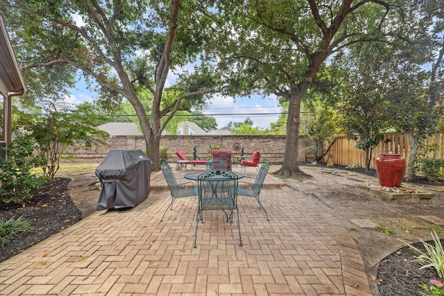 718 Marywood Chase, Houston, TX 77079 - fenced backyard featuring grilling area, a patio, and outdoor dining area