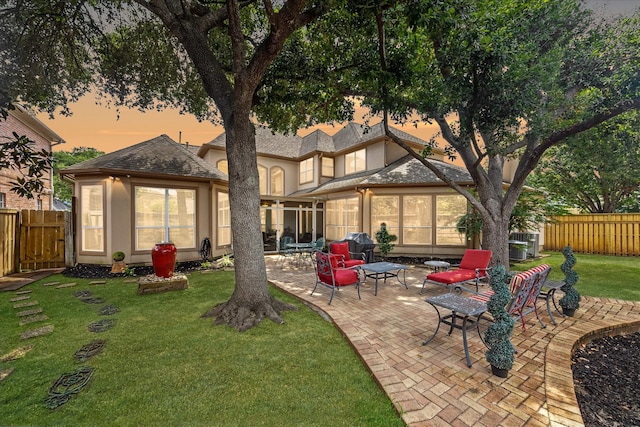 718 Marywood Chase, Houston, TX 77079 - back of property at dusk featuring a patio and a shingled roof