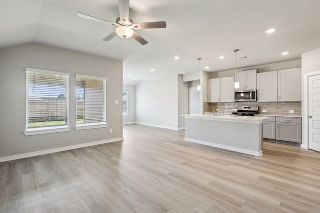 8614 Lake Groove Ln, Baytown, TX 77523 - kitchen with appliances with stainless steel finishes, open floor plan, backsplash, light countertops, and ceiling fan