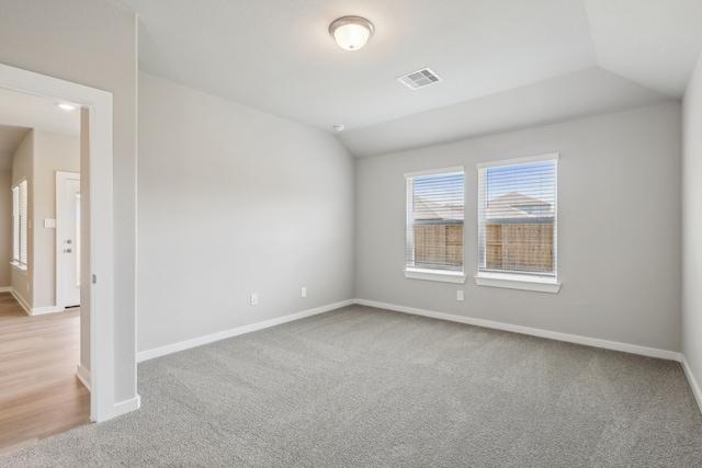 8614 Lake Groove Ln, Baytown, TX 77523 - carpeted spare room with vaulted ceiling and baseboards