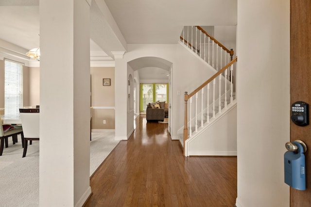 4146 S Webber Dr, Pearland, TX 77584 - entrance foyer with arched walkways, stairway, and wood finished floors
