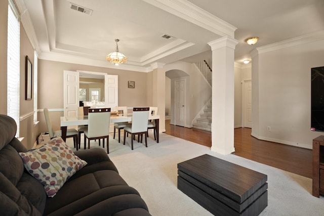 4146 S Webber Dr, Pearland, TX 77584 - living area featuring decorative columns, arched walkways, stairway, crown molding, and a raised ceiling