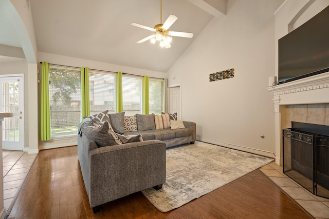 4146 S Webber Dr, Pearland, TX 77584 - living area featuring a ceiling fan, wood finished floors, high vaulted ceiling, a fireplace, and beam ceiling