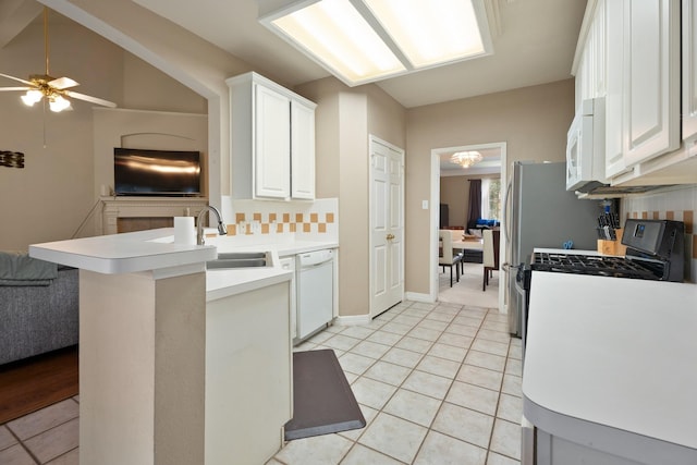 4146 S Webber Dr, Pearland, TX 77584 - kitchen with white appliances, light tile patterned floors, a peninsula, white cabinets, and light countertops