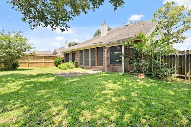 4146 S Webber Dr, Pearland, TX 77584 - rear view of house featuring a chimney and brick siding