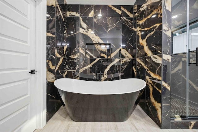 5711 Sudan St, Houston, TX 77020 - full bath with tile walls, a soaking tub, and a shower stall