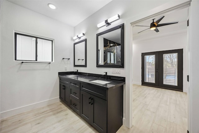 5711 Sudan St, Houston, TX 77020 - bathroom with double vanity, wood finished floors, french doors, ceiling fan, and recessed lighting