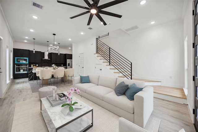 5711 Sudan St, Houston, TX 77020 - living area with recessed lighting, stairway, a chandelier, crown molding, and a ceiling fan