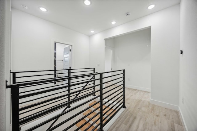 5711 Sudan St, Houston, TX 77020 - corridor with an upstairs landing, light wood-style floors, and recessed lighting