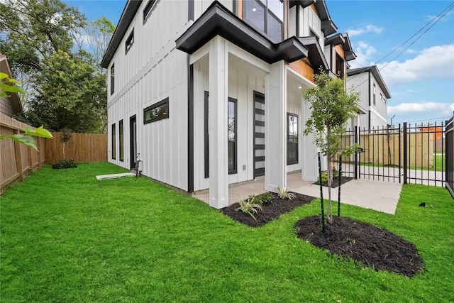 5711 Sudan St, Houston, TX 77020 - view of side of home with board and batten siding, a fenced backyard, and a patio area