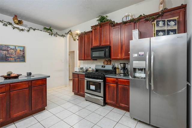 13703 Naples Park Ln, Houston, TX 77070 - kitchen with appliances with stainless steel finishes, reddish brown cabinets, and dark countertops