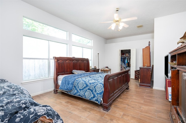 13703 Naples Park Ln, Houston, TX 77070 - bedroom with light wood-style floors, a walk in closet, a closet, and ceiling fan