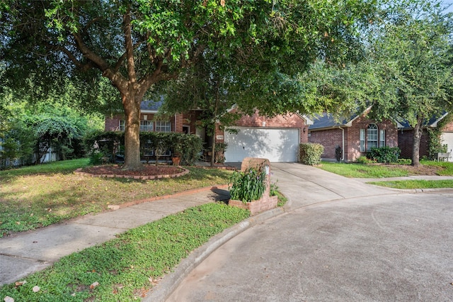 13703 Naples Park Ln, Houston, TX 77070 - view of property hidden behind natural elements with brick siding, driveway, an attached garage, and a front yard