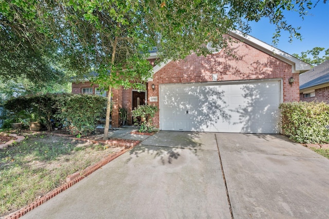 13703 Naples Park Ln, Houston, TX 77070 - obstructed view of property featuring brick siding, a garage, and concrete driveway