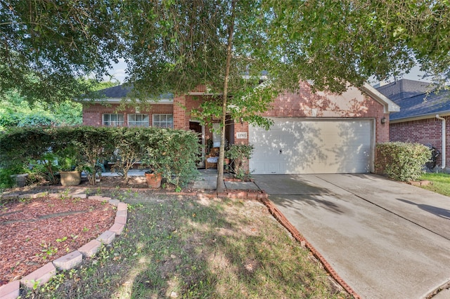 13703 Naples Park Ln, Houston, TX 77070 - view of property hidden behind natural elements featuring brick siding, concrete driveway, and an attached garage