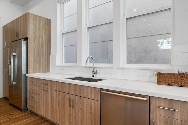 9809 Blissful Prairie Ln, Houston, TX 77080 - kitchen with stainless steel appliances, wood finished floors, backsplash, and modern cabinets