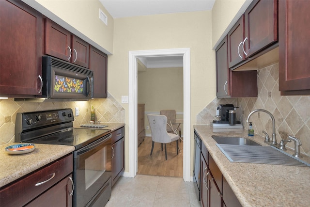 2700 Revere St Unit 147, Houston, TX 77098 - kitchen featuring black appliances, reddish brown cabinets, crown molding, decorative backsplash, and light tile patterned floors