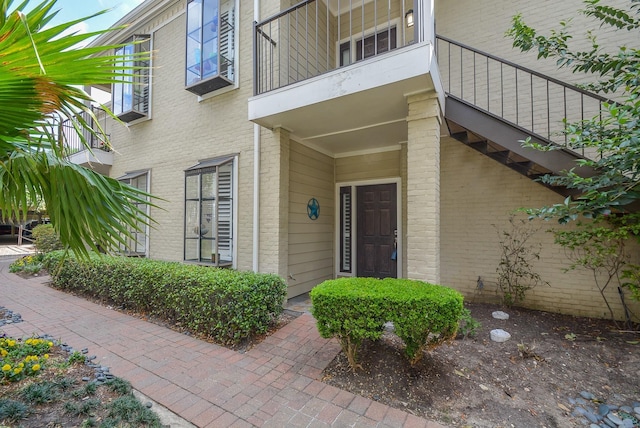 2700 Revere St Unit 147, Houston, TX 77098 - view of exterior entry with a balcony and brick siding
