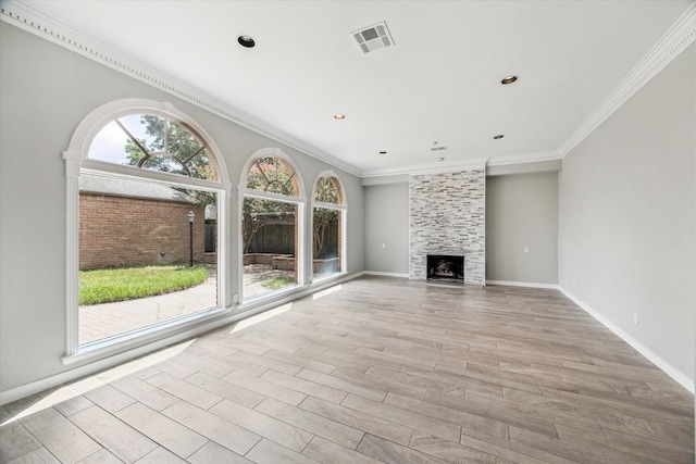 11602 Aspenway Dr, Houston, TX 77070 - unfurnished living room with crown molding, light wood-style floors, and a tile fireplace