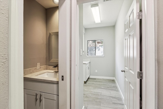 11602 Aspenway Dr, Houston, TX 77070 - bathroom with vanity, wood finished floors, and a textured wall