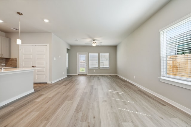 8615 Lake Groove Ln, Baytown, TX 77523 - unfurnished living room with a ceiling fan, light wood finished floors, and recessed lighting