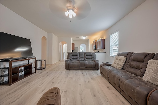 30914 Sweetwater Cir, Magnolia, TX 77355 - living room featuring arched walkways, a ceiling fan, and light wood finished floors