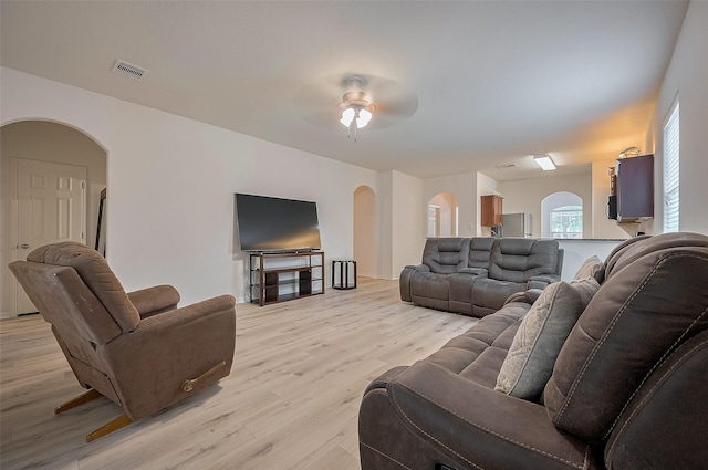 30914 Sweetwater Cir, Magnolia, TX 77355 - living area with arched walkways, light wood-type flooring, and a ceiling fan