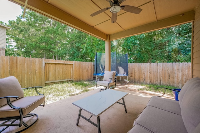 30914 Sweetwater Cir, Magnolia, TX 77355 - fenced backyard with a trampoline, a patio area, and ceiling fan