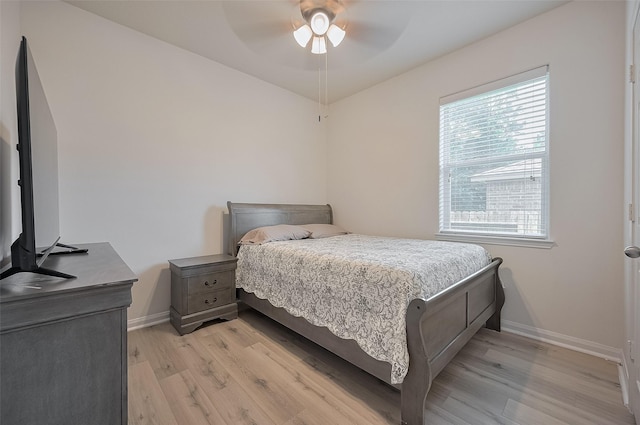 30914 Sweetwater Cir, Magnolia, TX 77355 - bedroom featuring light wood-type flooring, multiple windows, and a ceiling fan