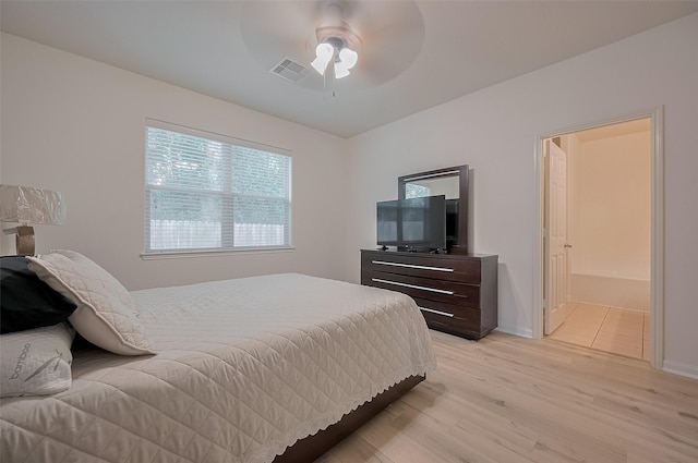 30914 Sweetwater Cir, Magnolia, TX 77355 - bedroom with light wood-type flooring, a ceiling fan, and connected bathroom