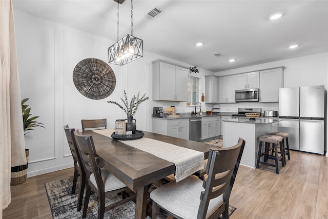 1100 Greenshank Dr, Katy, TX 77493 - dining area with light wood-style floors, a chandelier, and recessed lighting