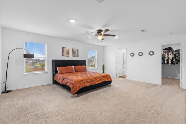 1100 Greenshank Dr, Katy, TX 77493 - bedroom featuring light carpet, a walk in closet, ceiling fan, ensuite bath, and recessed lighting