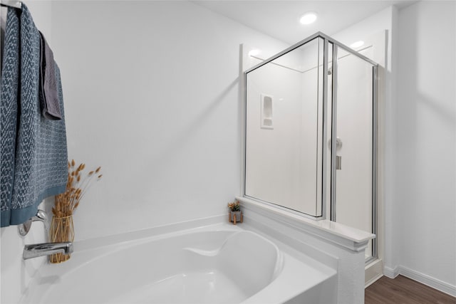 1100 Greenshank Dr, Katy, TX 77493 - bathroom with a garden tub, a stall shower, and wood finished floors