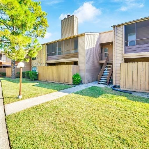 10555 Turtlewood Ct Unit 1803, Houston, TX 77072 - back of house with a chimney and stairway