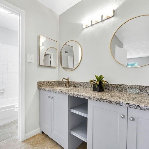 10555 Turtlewood Ct Unit 1803, Houston, TX 77072 - bathroom with vanity and bathtub / shower combination