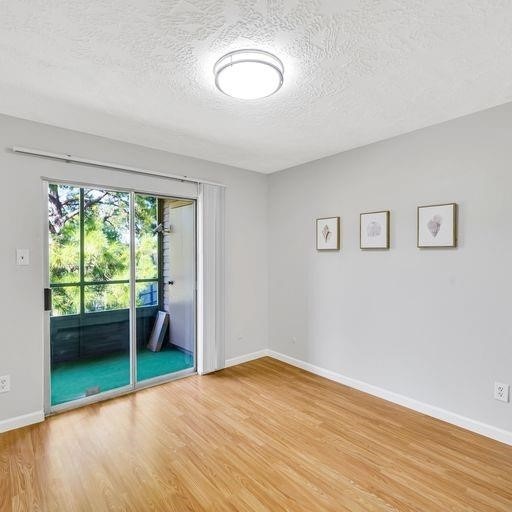10555 Turtlewood Ct Unit 1803, Houston, TX 77072 - unfurnished room with light wood-style flooring and a textured ceiling