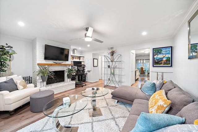 10333 Longmont Dr Unit 35/3, Houston, TX 77042 - living room with crown molding, ceiling fan, wood finished floors, a brick fireplace, and recessed lighting