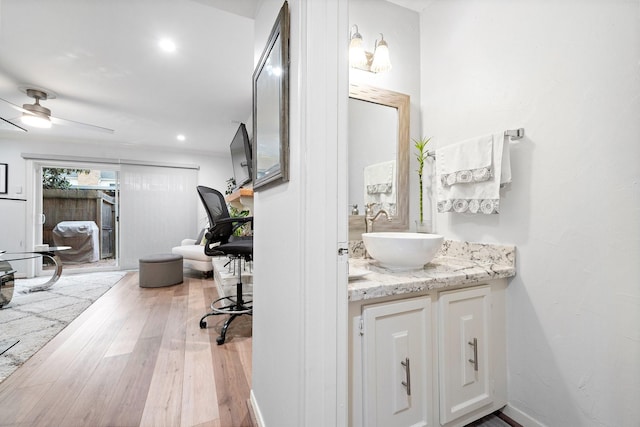 10333 Longmont Dr Unit 35/3, Houston, TX 77042 - bathroom featuring wood-type flooring, vanity, a ceiling fan, and recessed lighting