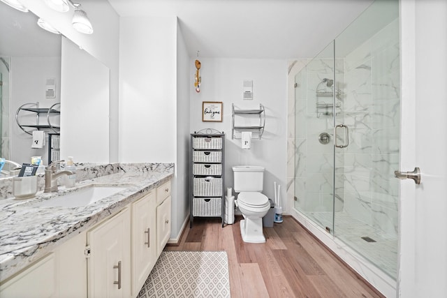 10333 Longmont Dr Unit 35/3, Houston, TX 77042 - bathroom featuring wood finished floors, vanity, and a marble finish shower