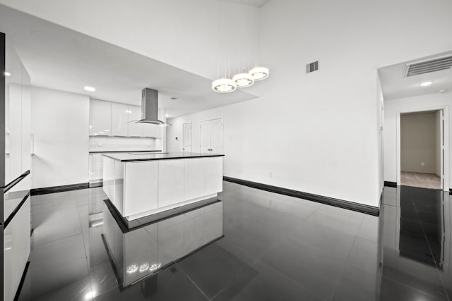 2015 Treasure Mountain Dr, Spring, TX 77388 - kitchen with wall chimney range hood, modern cabinets, white cabinetry, a kitchen island, and dark tile patterned floors