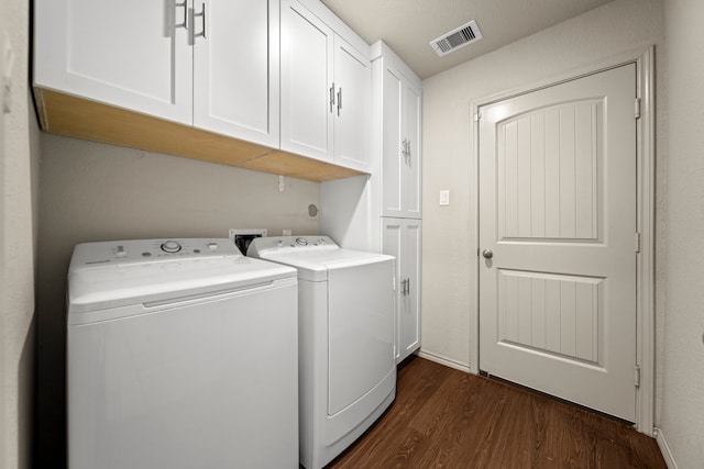 2015 Treasure Mountain Dr, Spring, TX 77388 - laundry room with cabinet space, washer and clothes dryer, and dark wood-style flooring