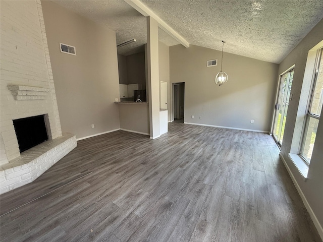 10052 Sharpton Dr, Houston, TX 77038 - unfurnished living room featuring a textured ceiling, healthy amount of natural light, dark wood-type flooring, a fireplace, and high vaulted ceiling