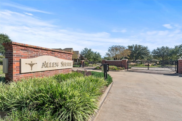 12207 Johns Enterprise Ct, Cypress, TX 77433 - community / neighborhood sign featuring a gate and concrete driveway