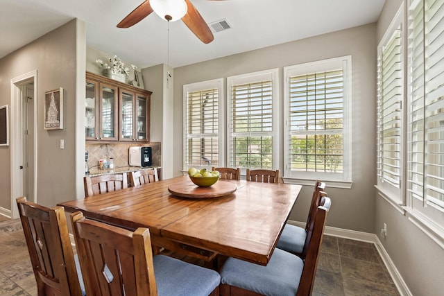 4419 Lea Ln, Fulshear, TX 77406 - dining space with stone tile floors, plenty of natural light, and a ceiling fan
