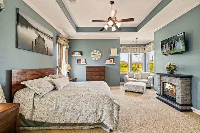 4419 Lea Ln, Fulshear, TX 77406 - carpeted bedroom featuring a raised ceiling, a ceiling fan, a glass covered fireplace, and crown molding